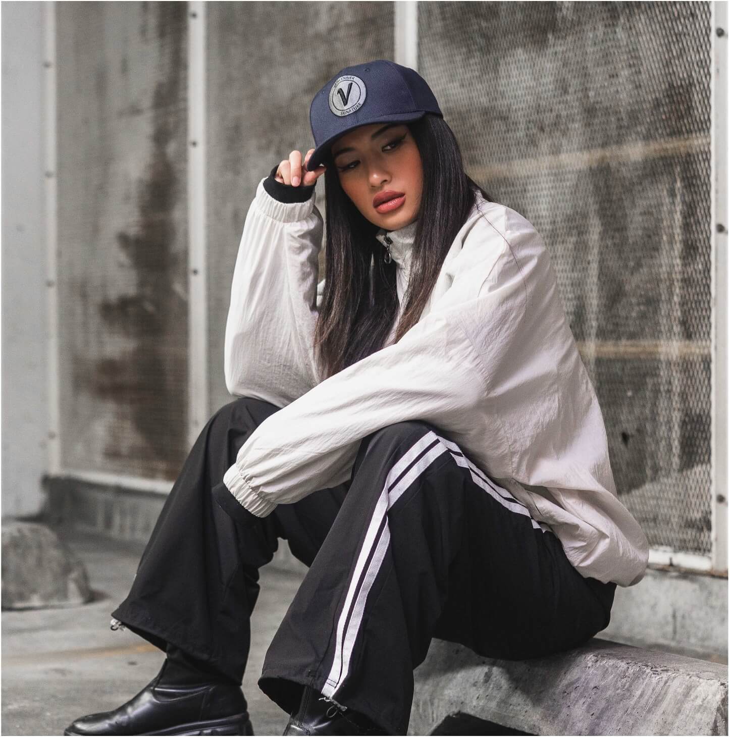Female model wearing the true-navy and black First-Up athleisure hat outdoors