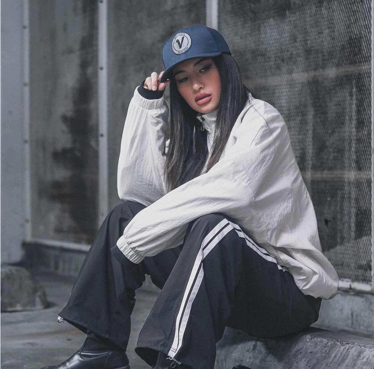 Female model wearing the true-navy and black First-Up lifestyle hat outdoors