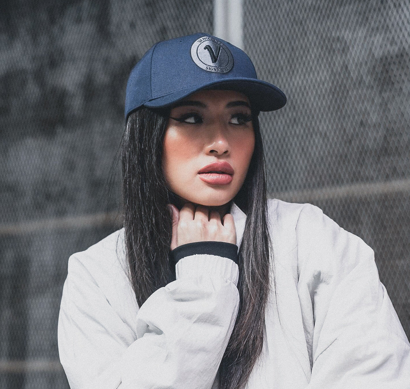 Close-up profile of a woman wearing the True-Navy and black First-Up lifestyle hat