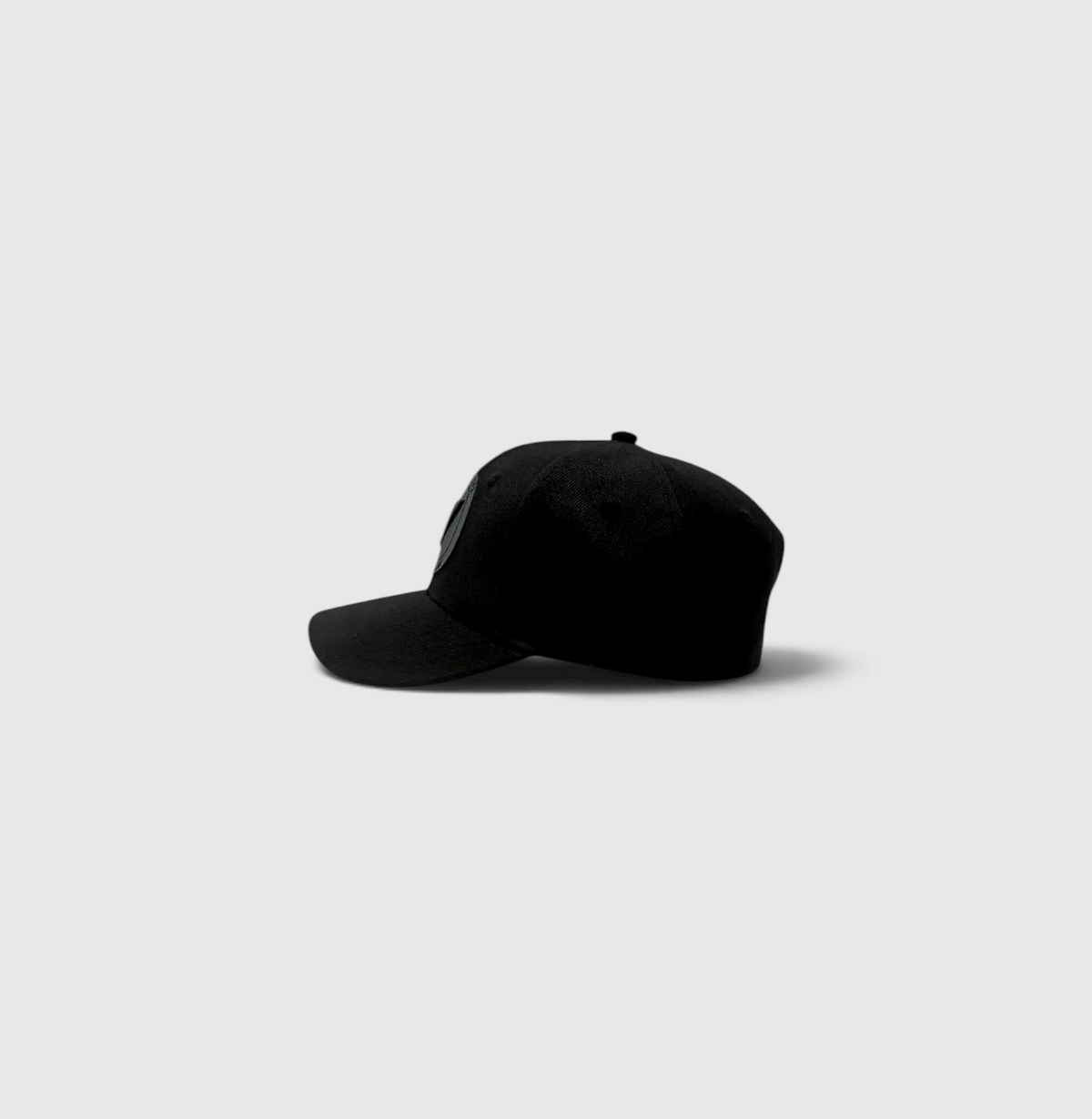 Side view of the onyx and black Listo premium structured hat by Vancouver Signature