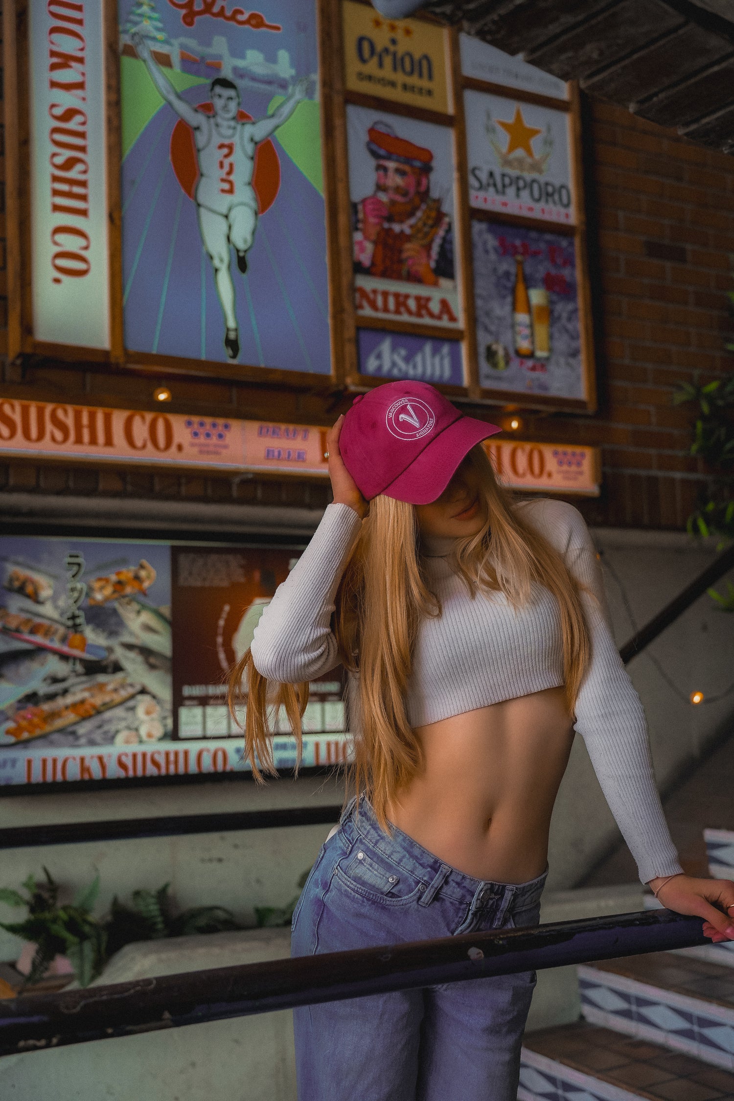 Female model wearing the burgundy and white Elation relaxed-fit hat by Vancouver Signature 