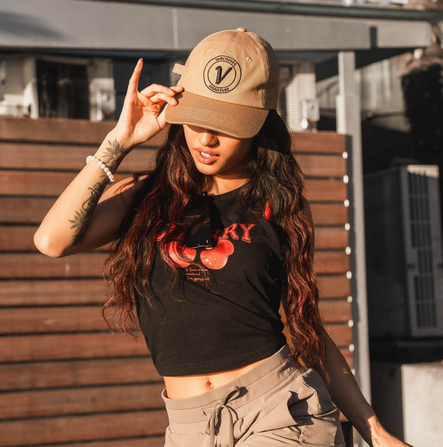 front profile of a woman wearing the sands and black Elation cotton hat