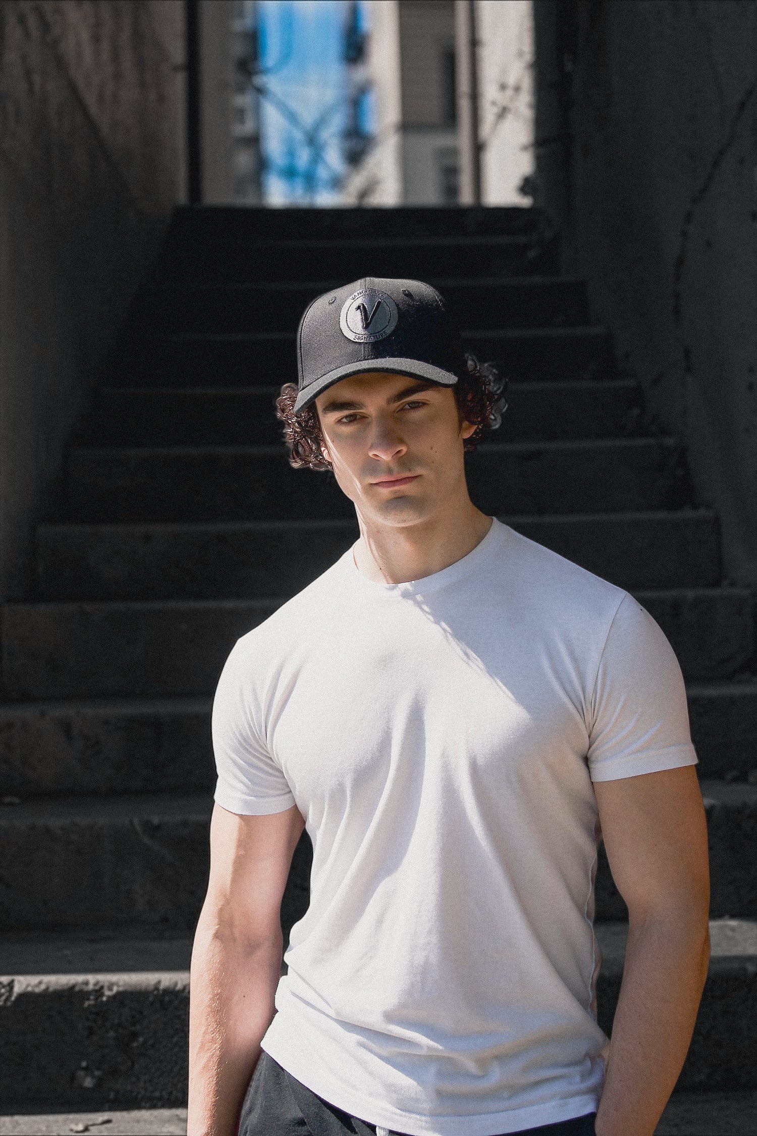 Male model looking at the camera and wearing the First Up hat by Vancouver Signature