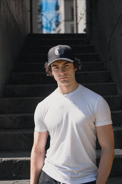 Male model looking at the camera and wearing the First Up hat by Vancouver Signature