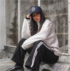 Female model wearing the true-navy and black First-Up athleisure hat outdoors