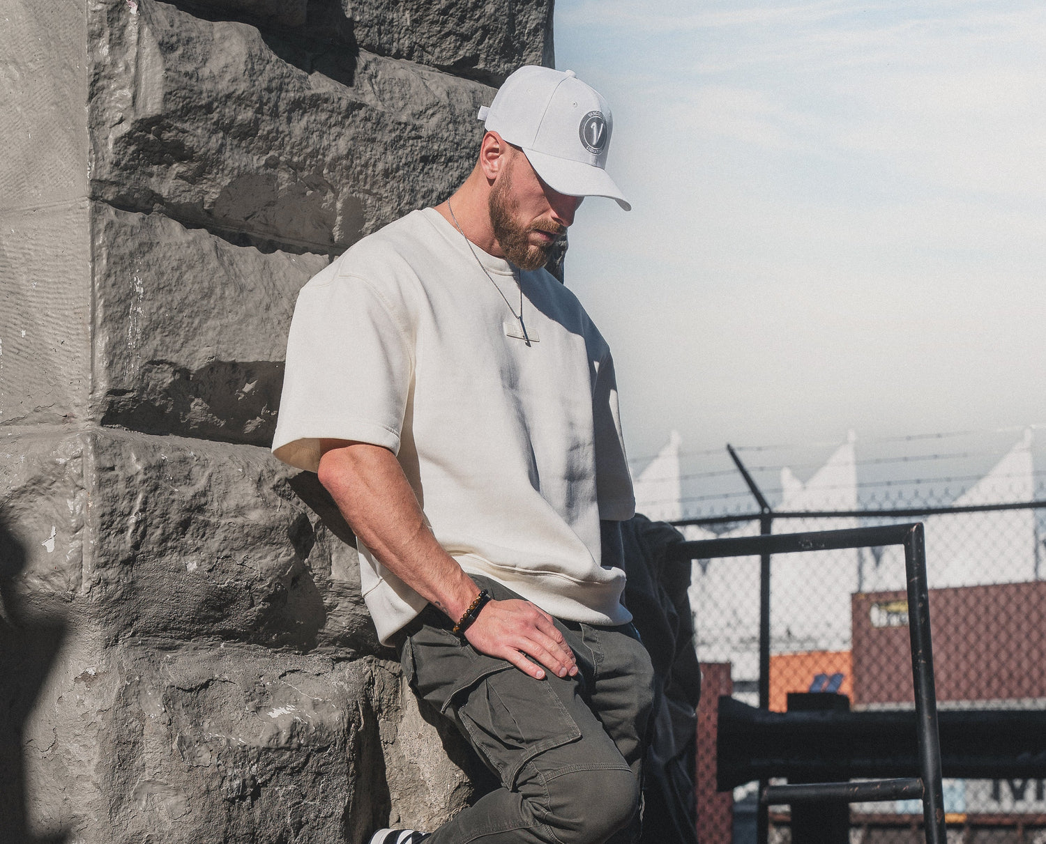 Male model wearing the white and white First-Up lifestyle hat outdoors in Vancouver