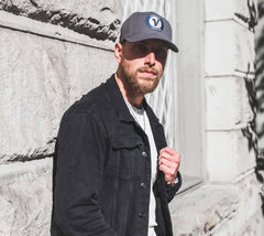 Man wearing Vancouver Signature Listo premium hat in stone and black outside