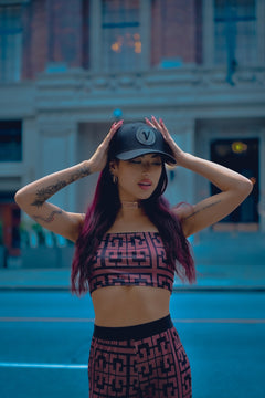Woman posing outdoors and wearing the Vancouver Signature Listo structured hat in onyx and black